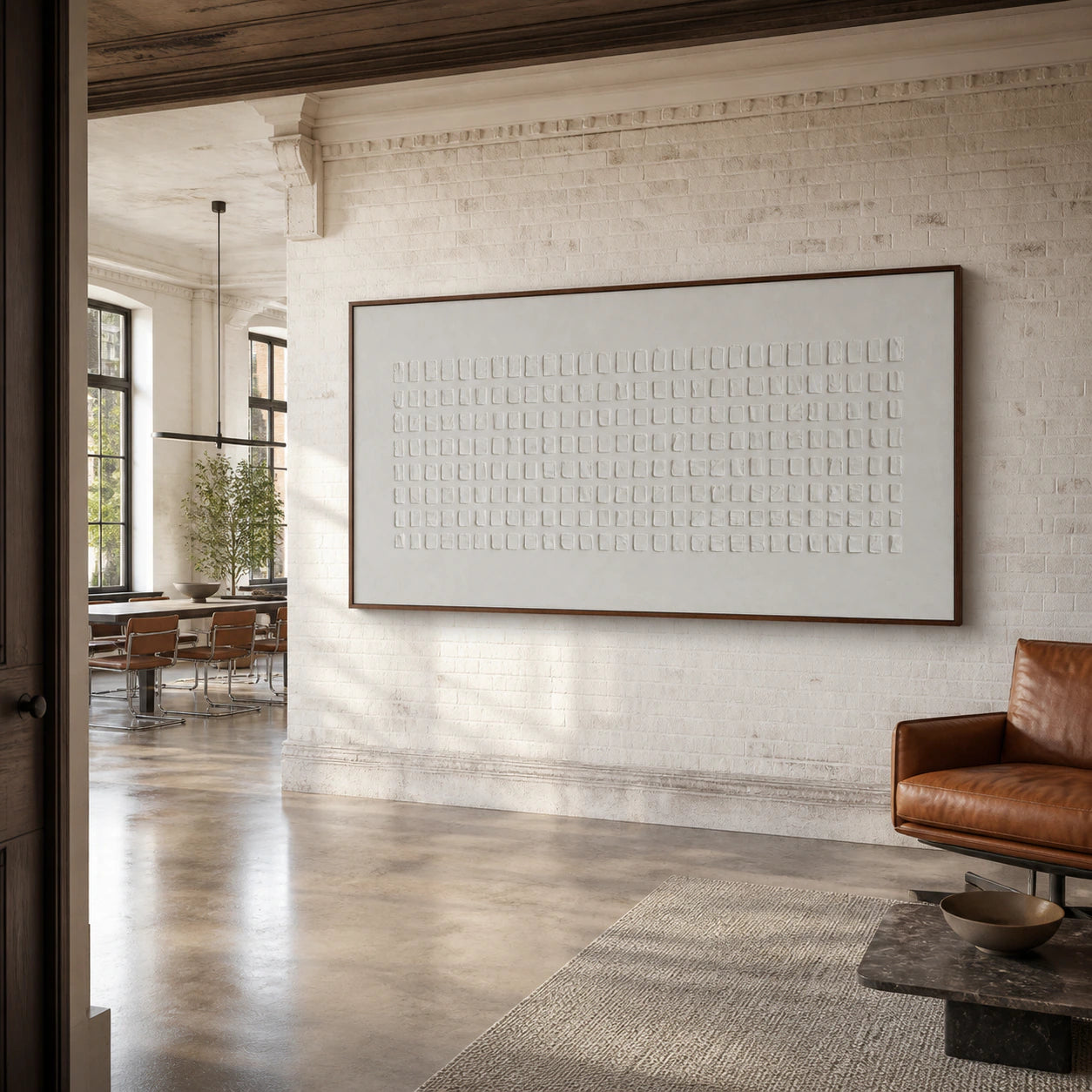 Expansive loft hospitality interior with the white geometric relief artwork as the visual anchor.