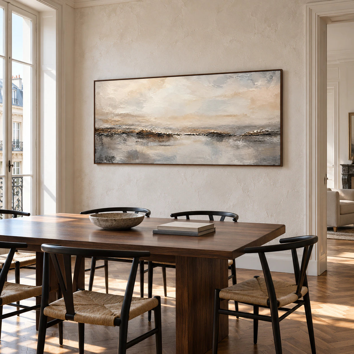 Wide abstract horizon artwork above a dark wood dining table in a refined, sunlit dining room.