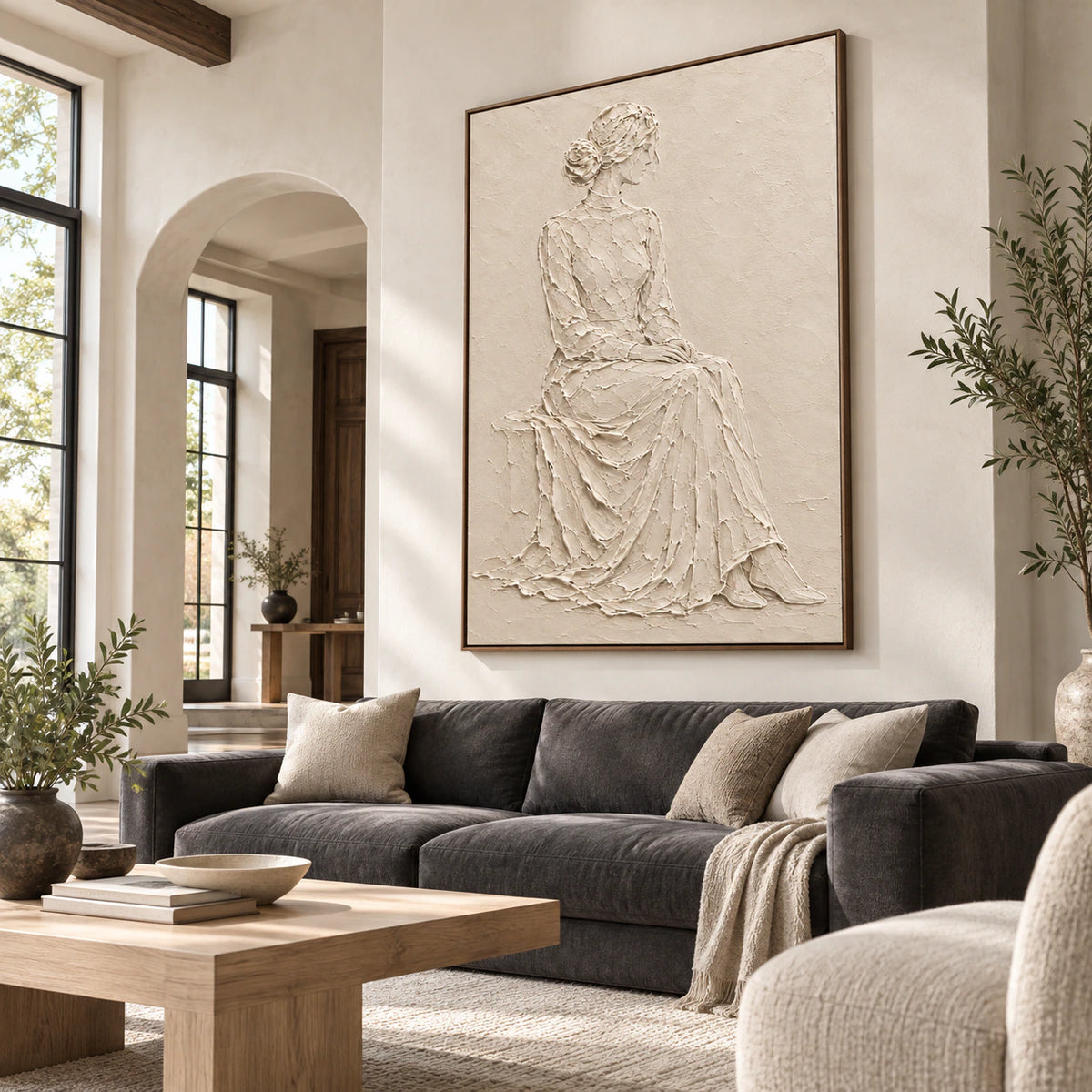 Quiet-Muse ivory textured figure artwork as the focal point of a bright contemporary living room.