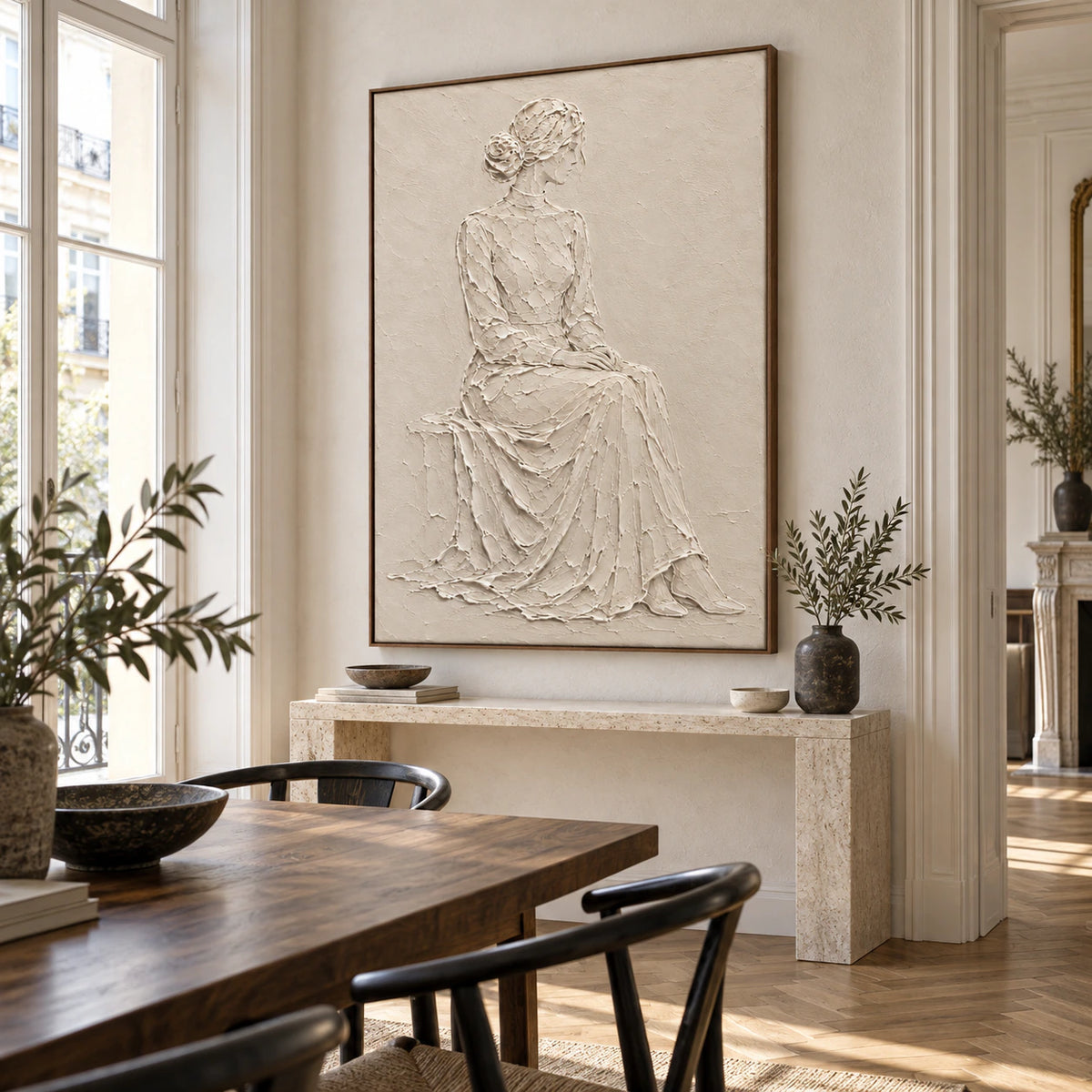Quiet-Muse ivory relief figure artwork above a refined dining setting in natural daylight.