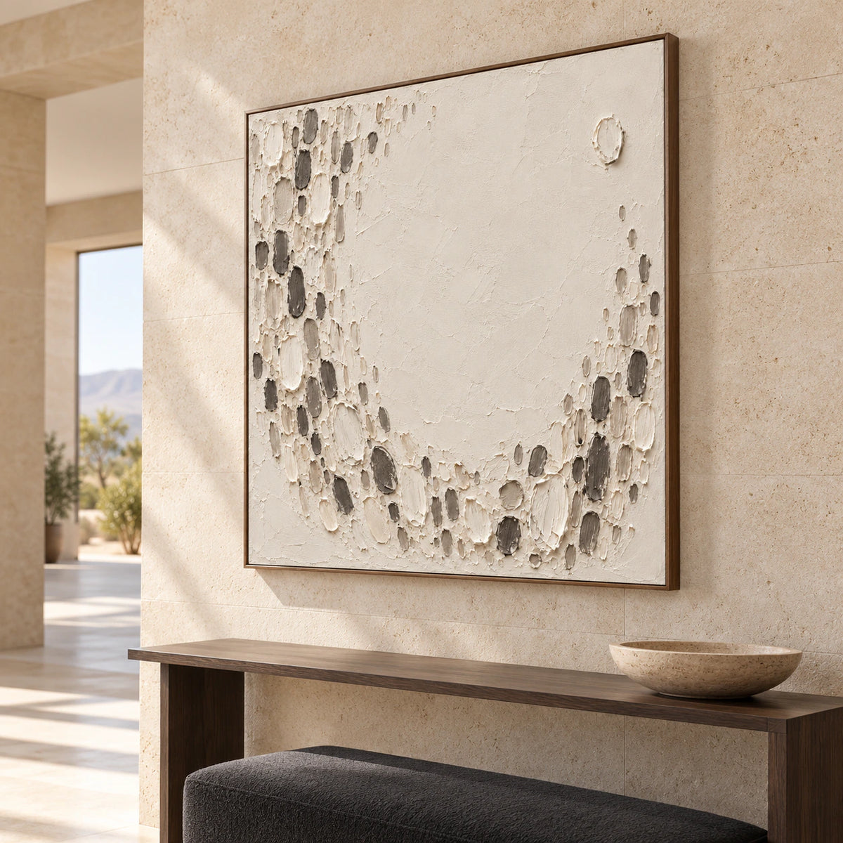 Large square ivory and charcoal textured abstract anchoring a bright, gallery-scale foyer.
