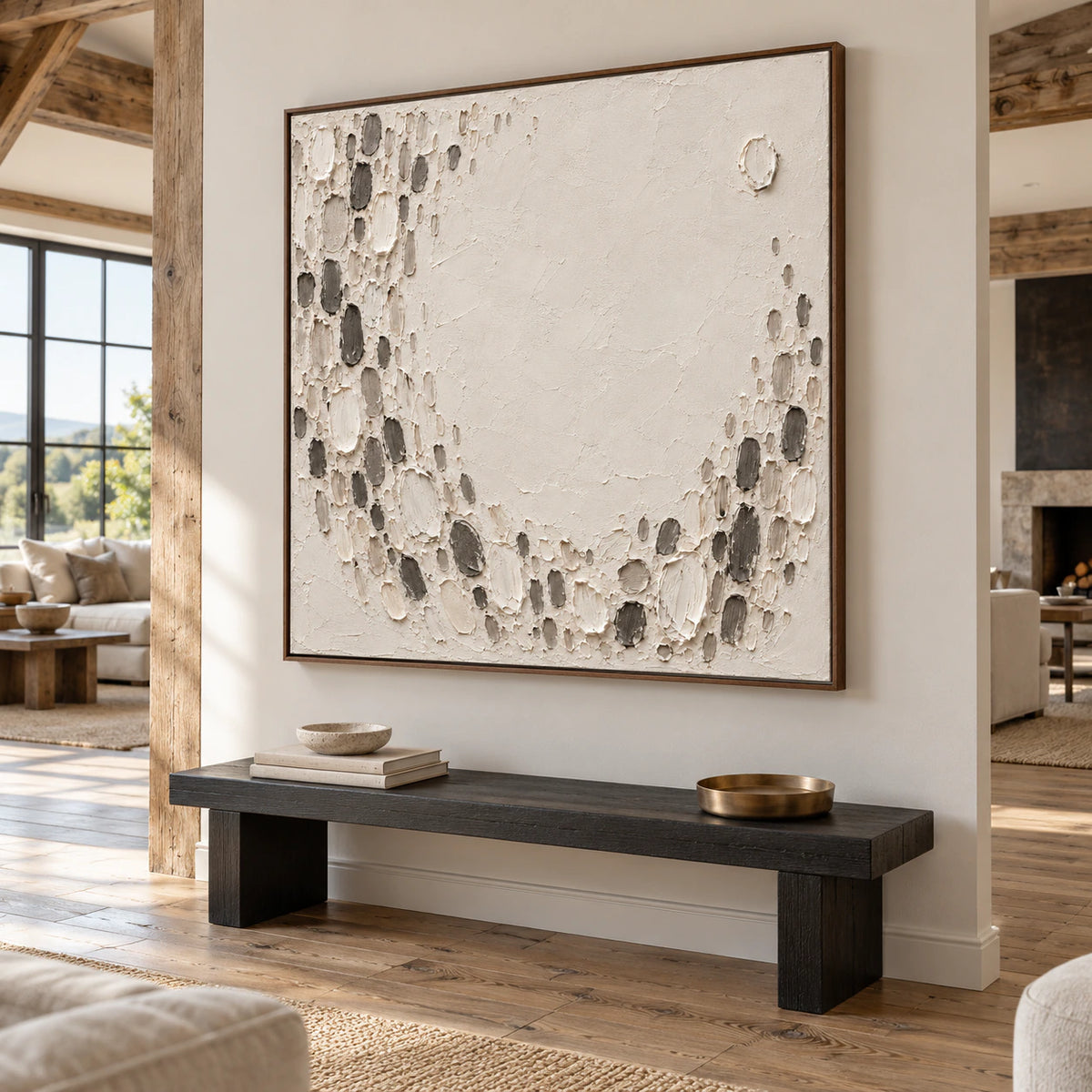Square ivory and charcoal textured abstract commanding the wall of an expansive, light-filled loft interior.