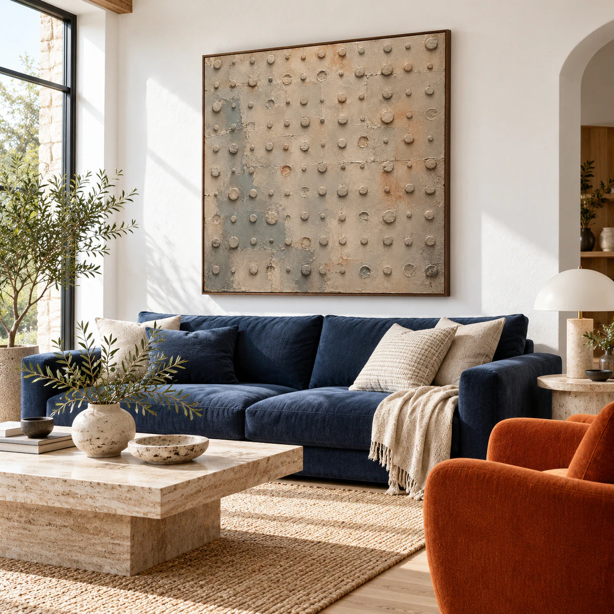 Quiet-Rivet above a restrained sofa in a bright contemporary living room.