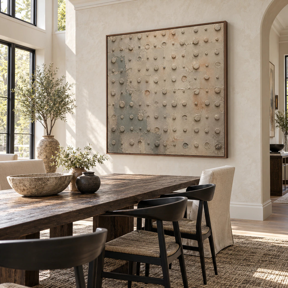 Quiet-Rivet as the focal artwork in a refined daylight dining room.