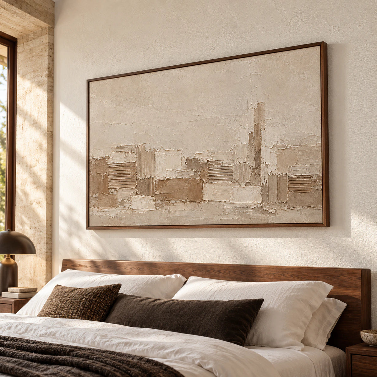 Raked Passage artwork hangs above a low walnut bed in a quiet, sunlit bedroom, viewed from the left at a gentle upward angle.