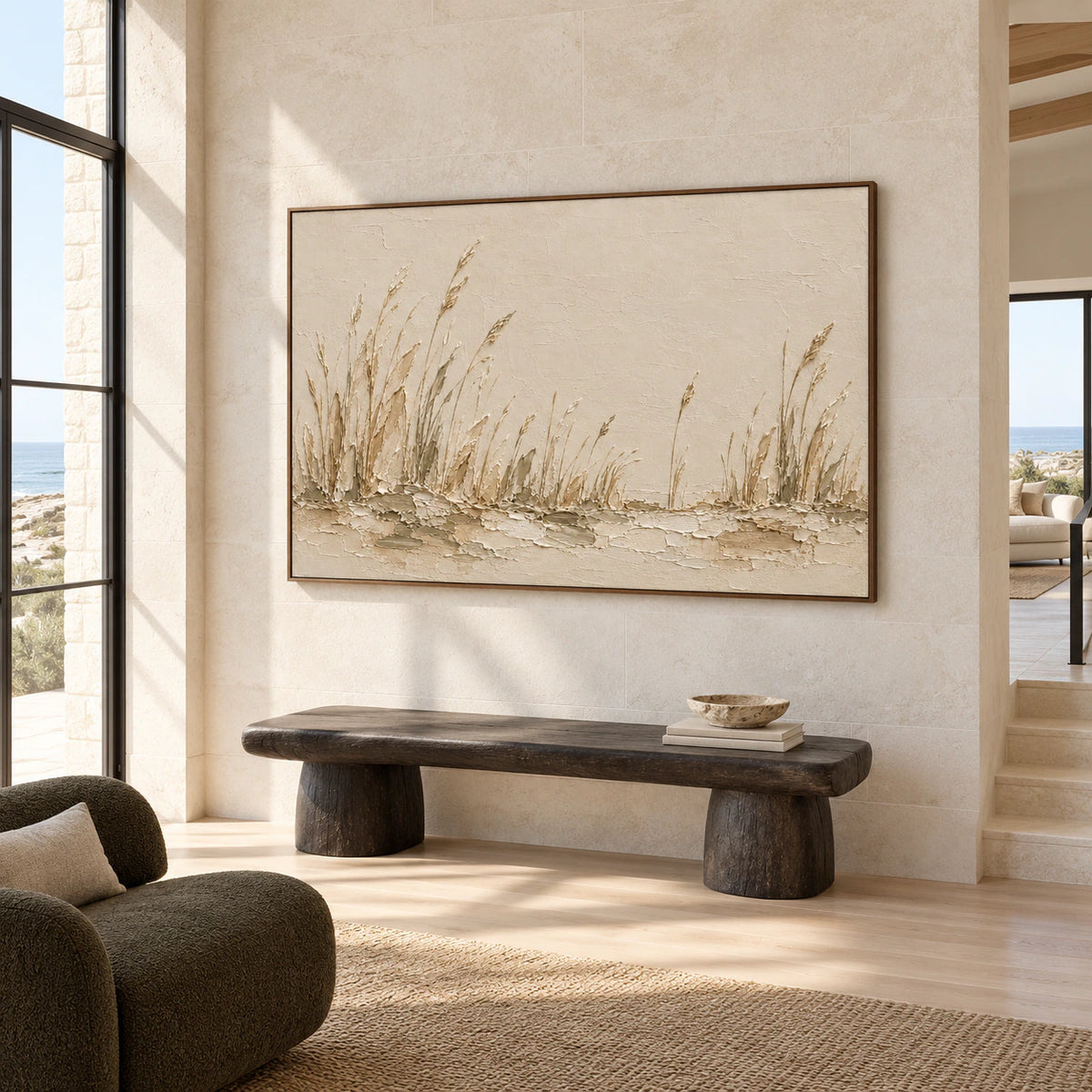 Low right-oblique view of a large reed landscape on a tall pale limestone wall in a spacious foyer with a dark sculptural bench.