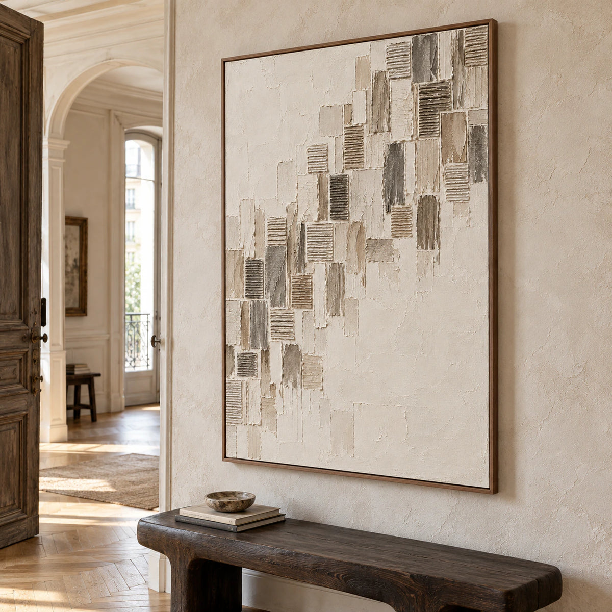Ribbed-Ascent commanding a pale stone foyer wall beside a sculptural dark bench, with open daylight and ample architectural space.
