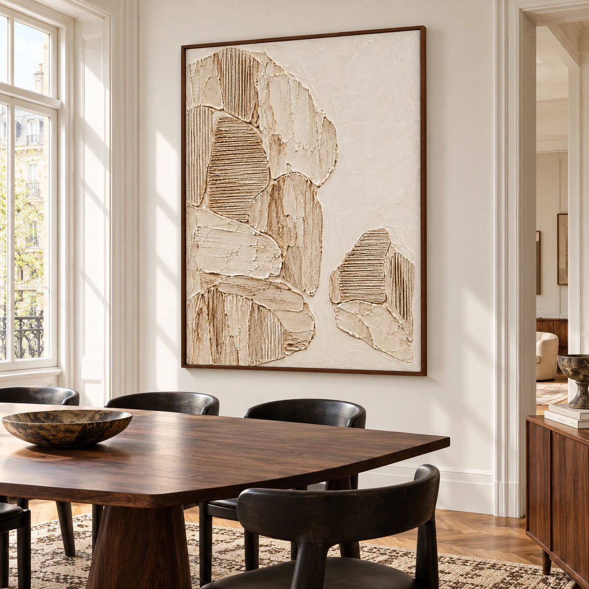 Ribbed parchment artwork commanding a refined dining room with a dark walnut table, sculptural chairs, and clear natural light.