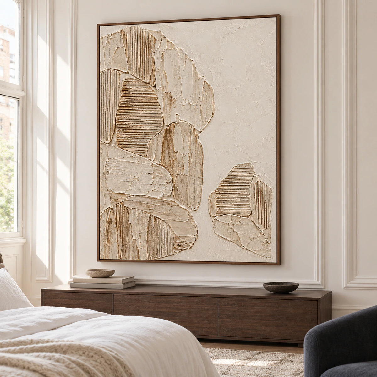 Parchment-toned textured artwork above a quiet bedroom console, with crisp white linen and soft morning light.