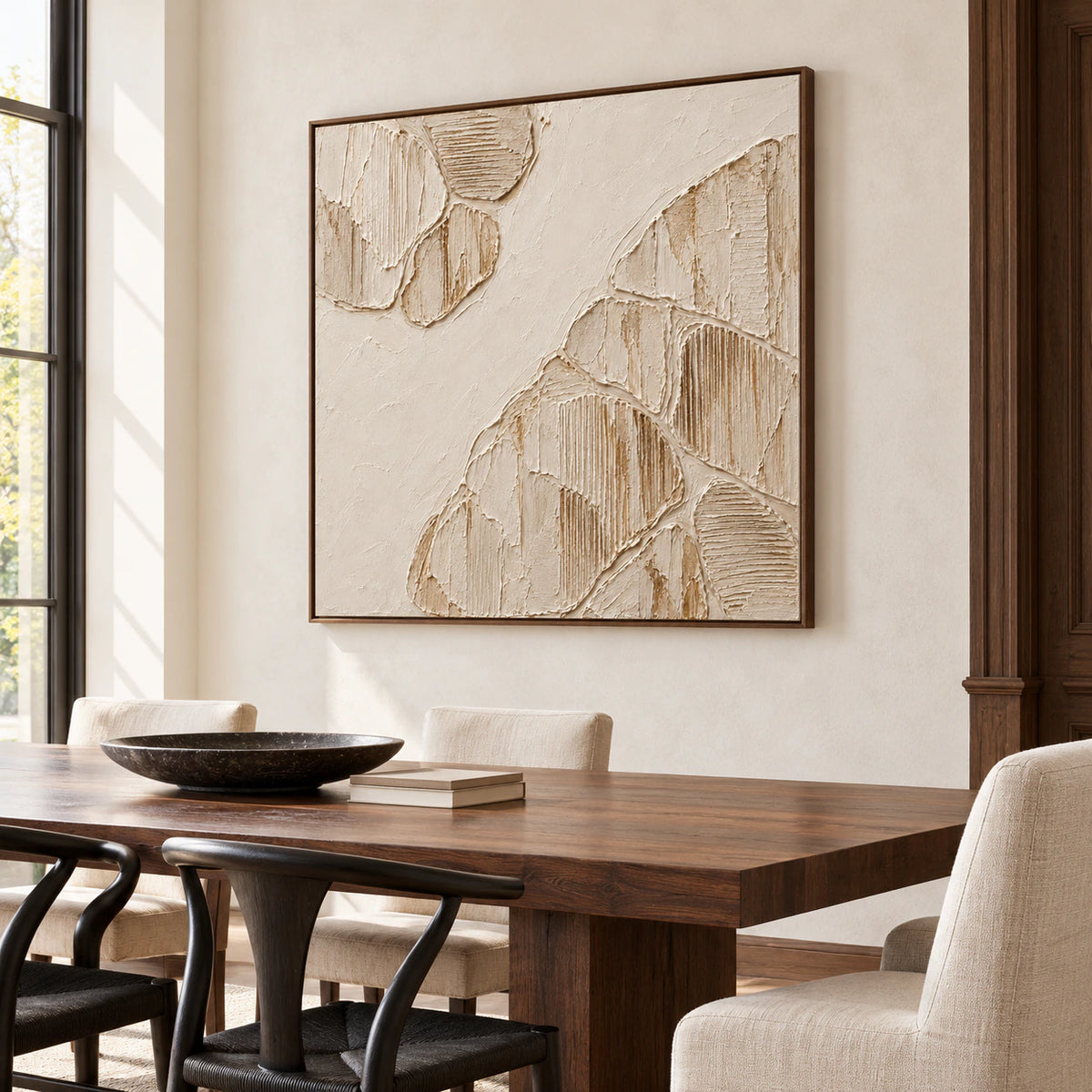 Large square ivory relief on a light plaster wall in a refined dining room, paired with a dark walnut table and understated chairs.