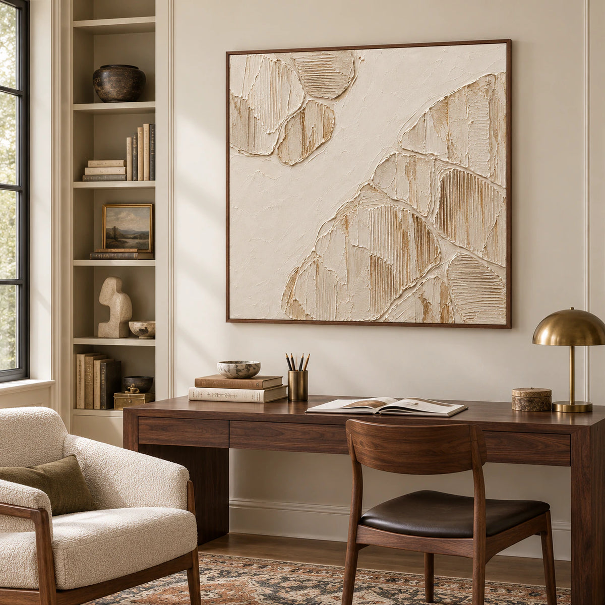 Large square ivory relief in an airy home office, above a dark wood desk with open shelving and soft daylight.