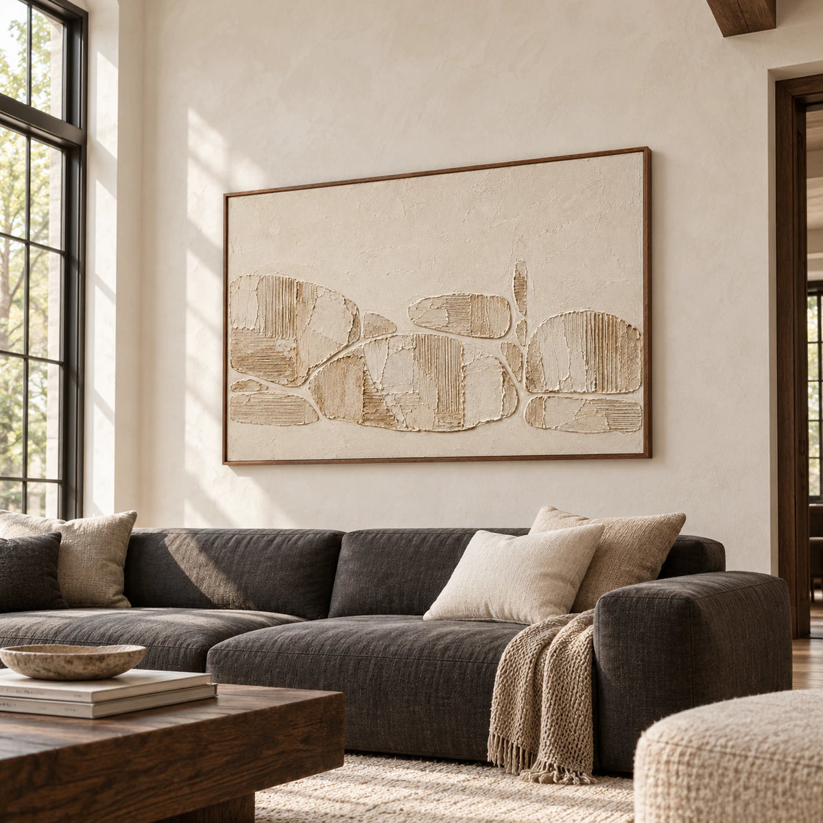 Ribbed Traverse displayed above a low charcoal sofa in a bright living room with tall windows and restrained furnishings.