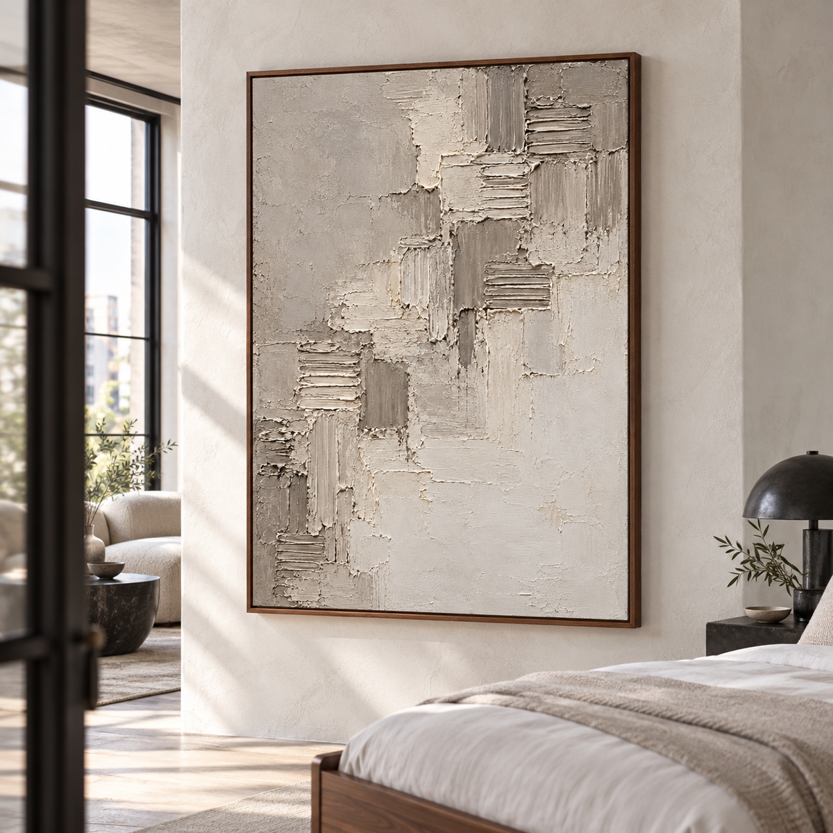 Riven-Cadence brings a quiet textured presence to a bright bedroom above a simple walnut bed and crisp neutral linens.