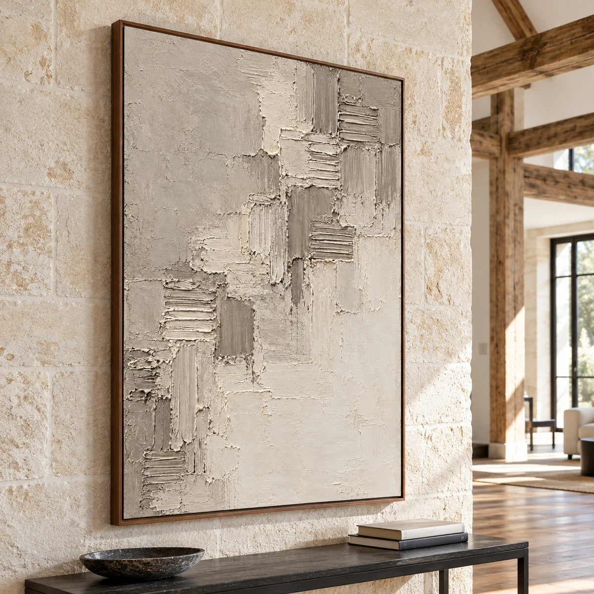 Gallery-scale Riven-Cadence anchors a bright foyer with limestone walls, a slim console and open architectural space.