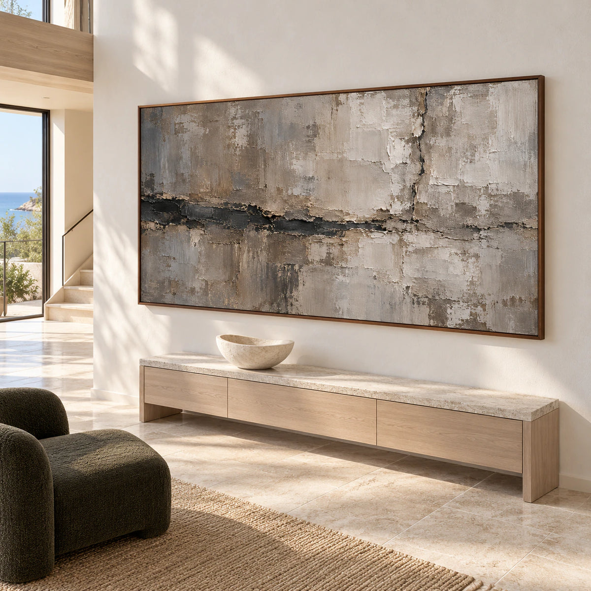 Riven-Mantle on a tall foyer wall above a slim console, with a stone floor and a sculptural accent, viewed from a low left angle.