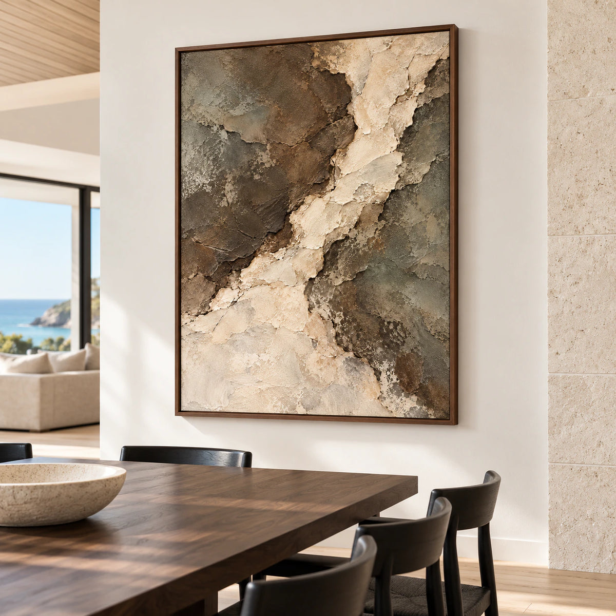 Riven-Passage viewed from the right in a bright dining room with pale limestone walls, a long dark wood table and black chairs.
