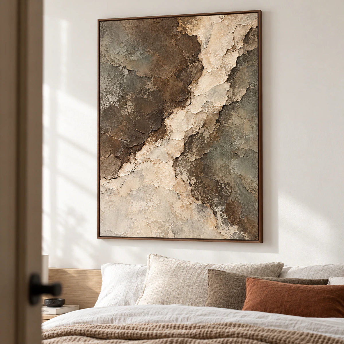 Riven-Passage above a low bed, viewed closely from the left at a low angle, with soft white walls, muted linen bedding and dark wood accents.