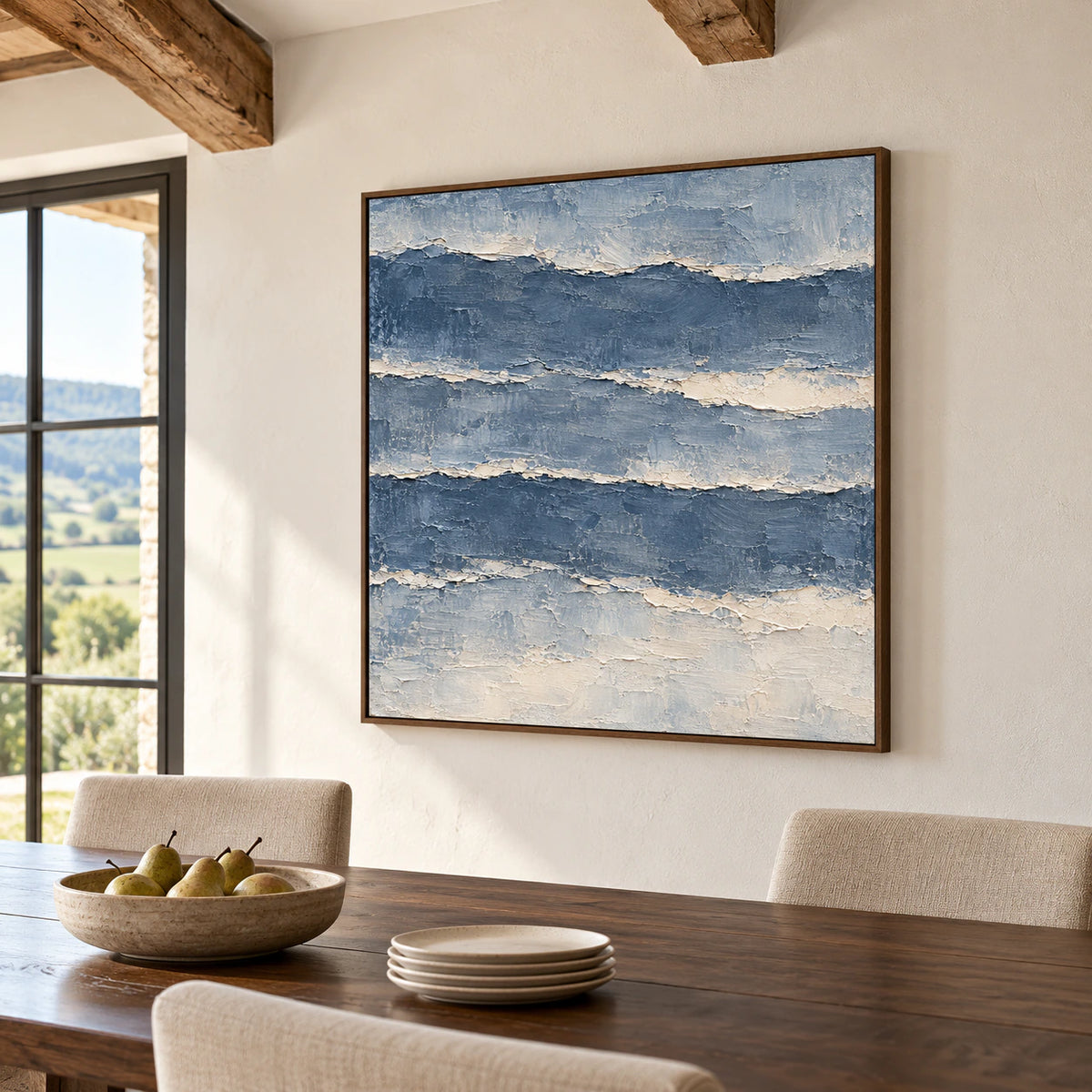 Riven-Tides painting on a warm white plaster wall above a dark wood dining table, viewed from the right at seated height.