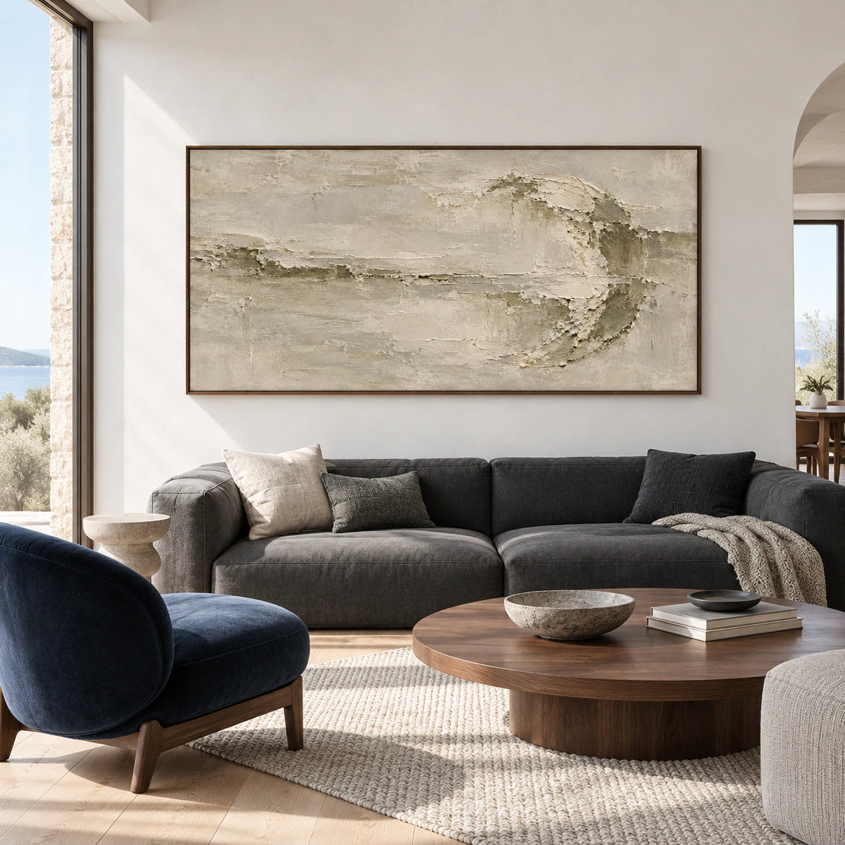 Riven-Wake displayed prominently above a restrained neutral sofa in a bright living room.