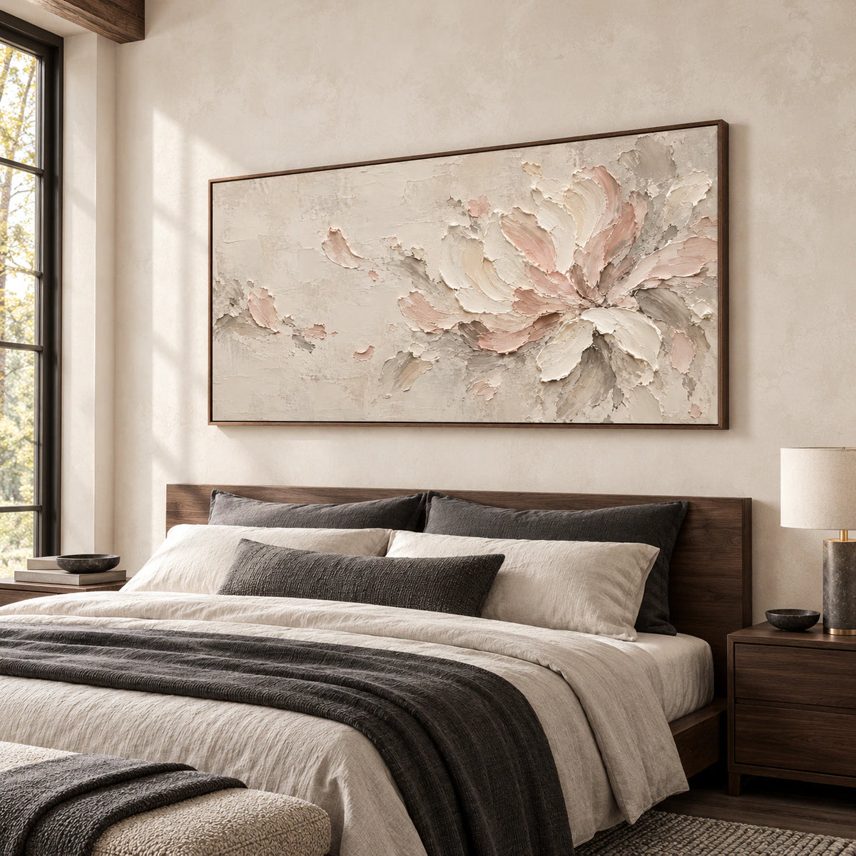 Ivory and blush floral abstract above a low walnut bed in a daylit bedroom, viewed from a slightly elevated left angle.
