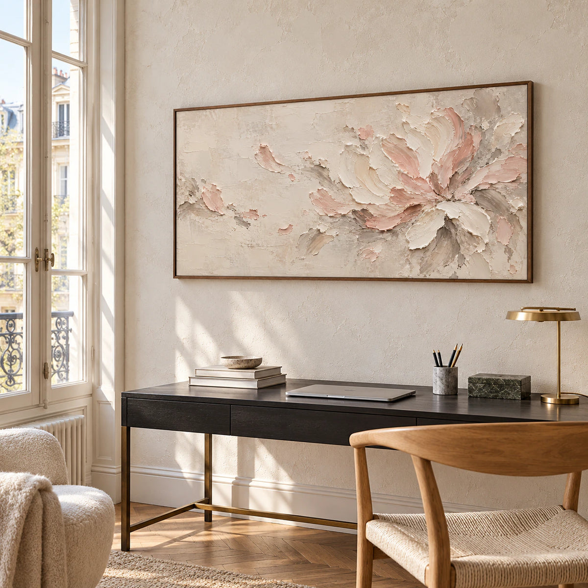 Horizontal floral abstract above a black writing desk in a bright home office and reading space, viewed from the right.
