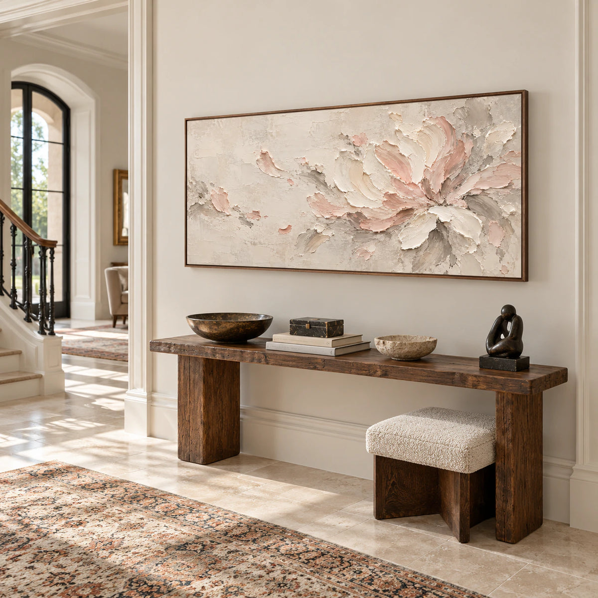 Large horizontal floral abstract in a bright, high-ceilinged foyer with a pale stone floor and minimal dark furnishings, viewed from the left.