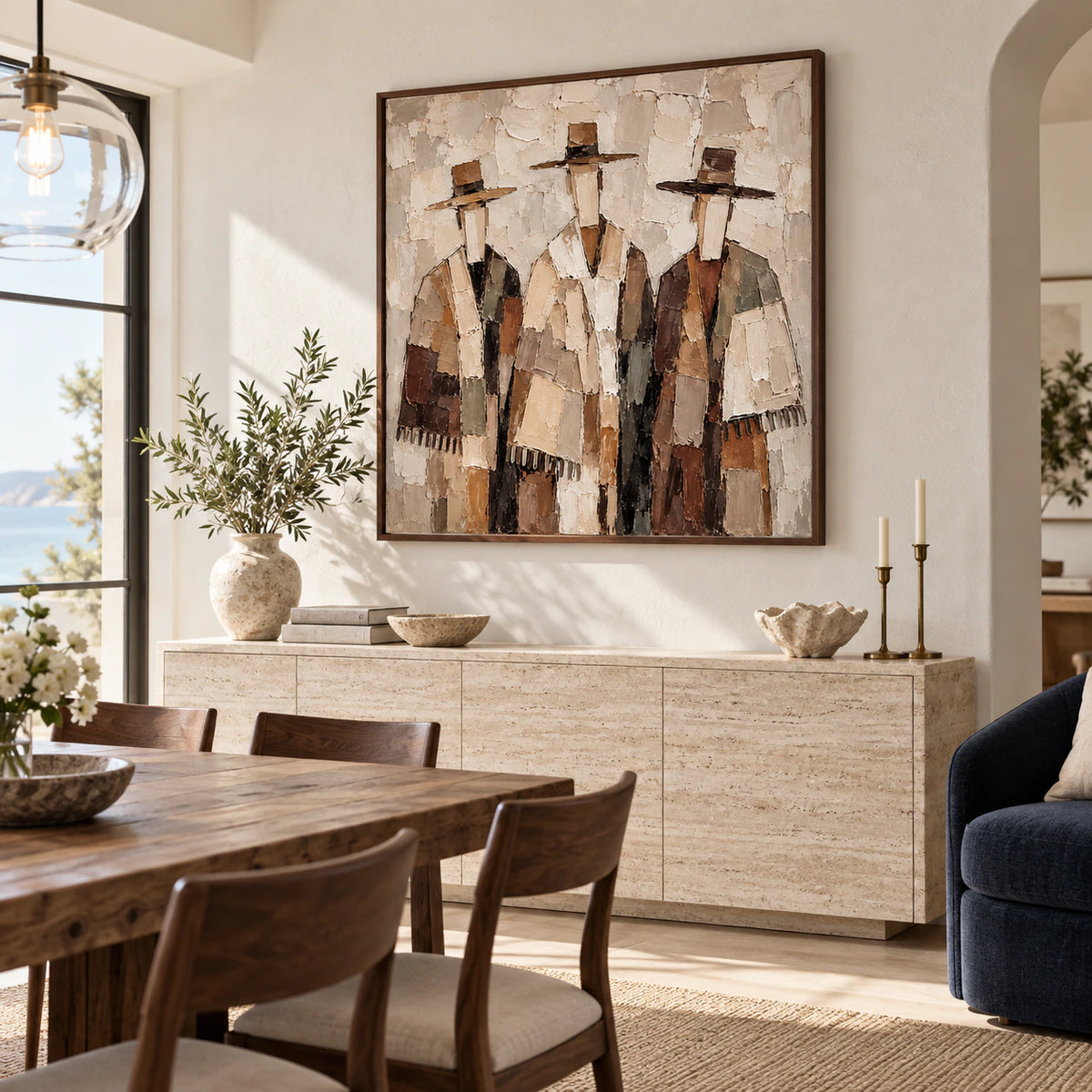 Textured square figure artwork above a dining room sideboard in a refined daylight interior.