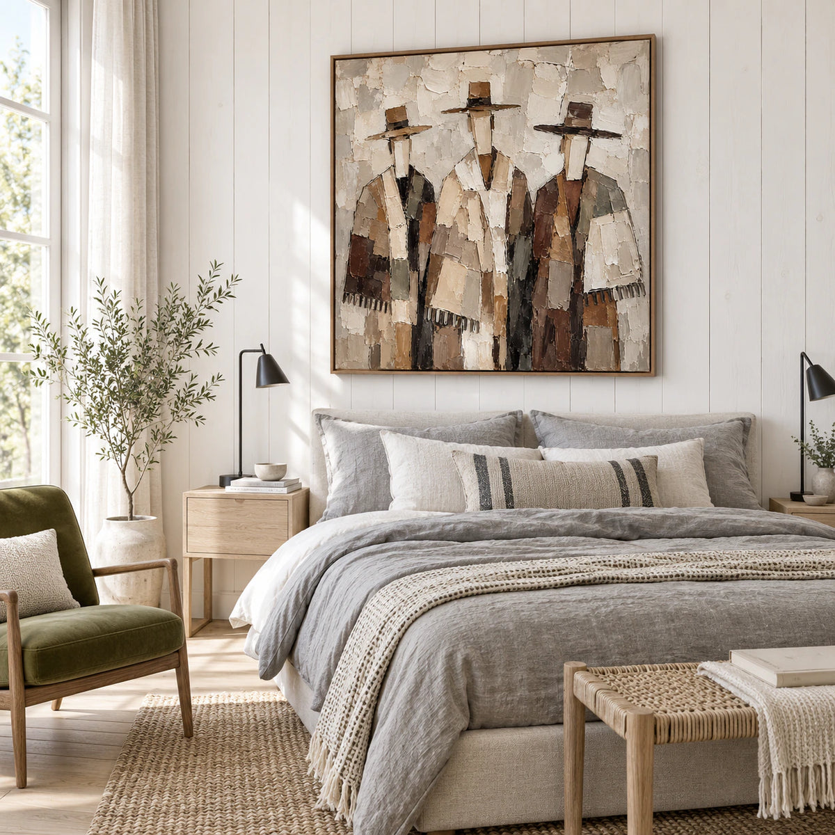 Square three-figure artwork above a linen-upholstered bed in a quiet bedroom.