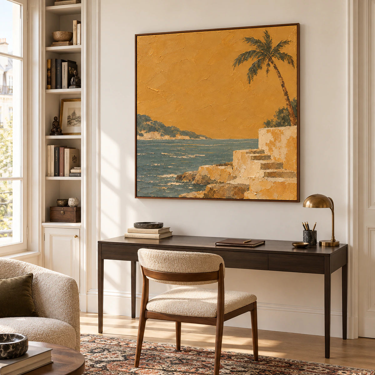 Square textured shore painting in an airy home office, above a slim dark desk with daylight falling across a pale wall.