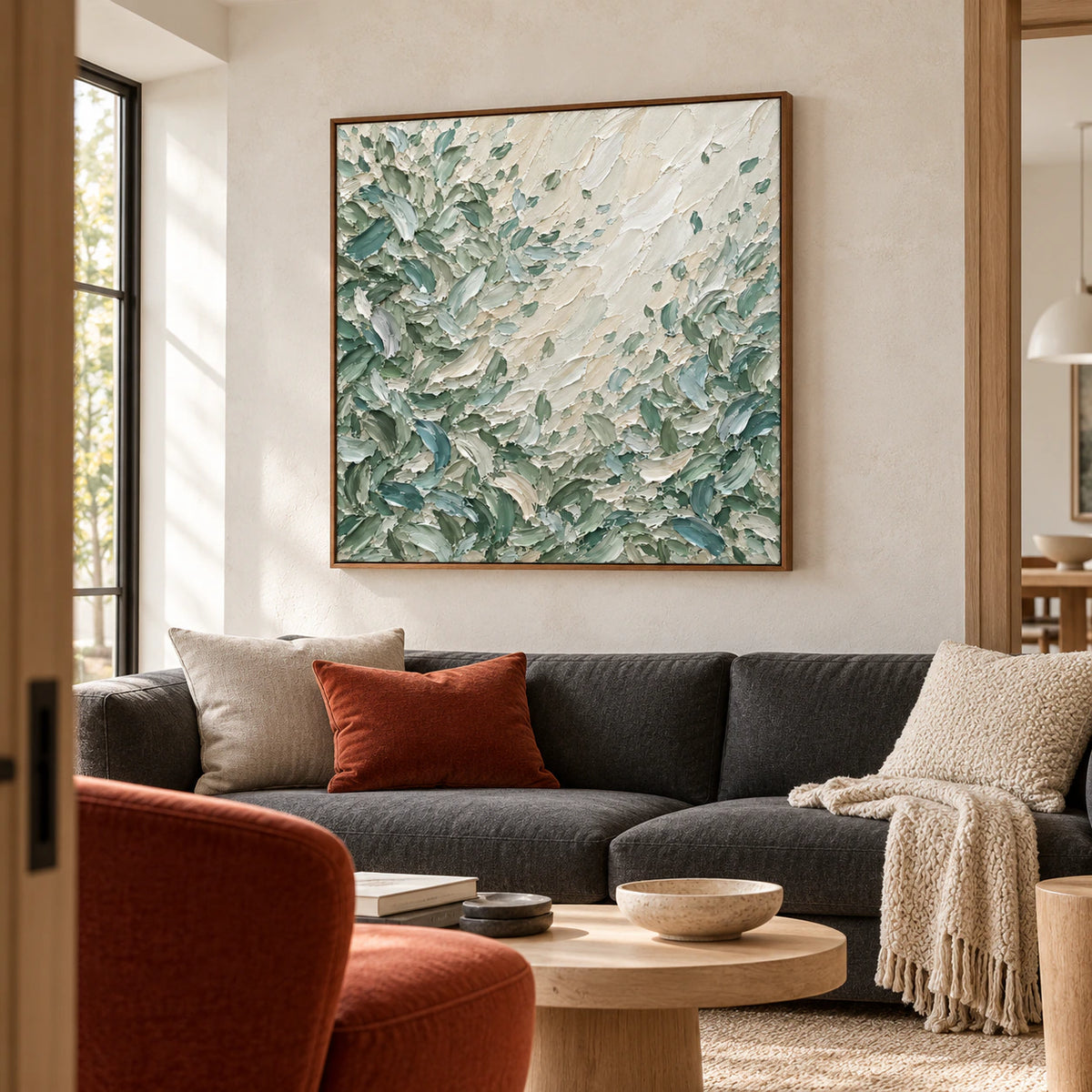 Large Sage-Rill artwork above a charcoal sofa in a bright living room with pale limestone walls and natural daylight.
