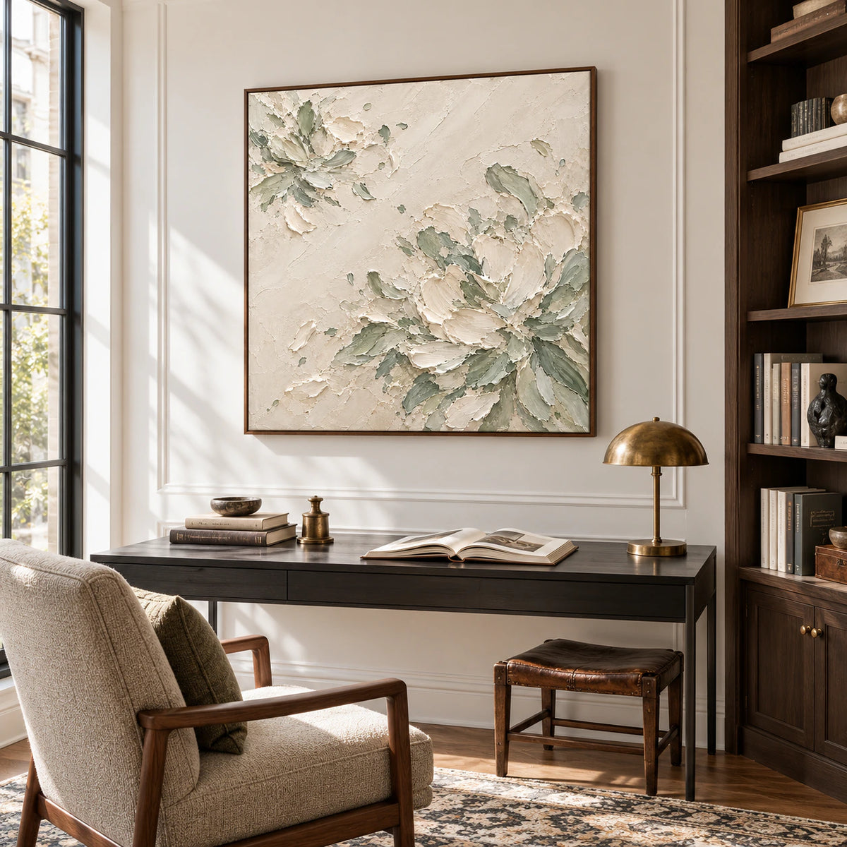 Square abstract painting displayed prominently in an airy home office beside a slim desk and dark timber shelving, lit by daylight.