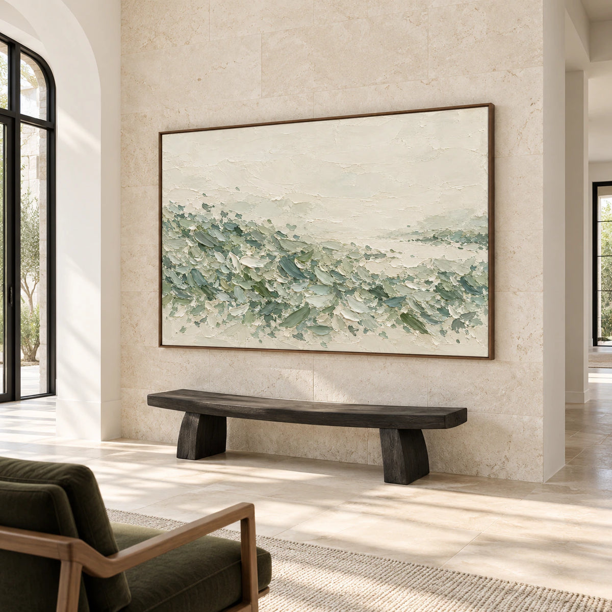 Horizontal ivory and sage painting anchoring a spacious foyer with limestone walls and a sculptural bench, seen from a slight side angle.