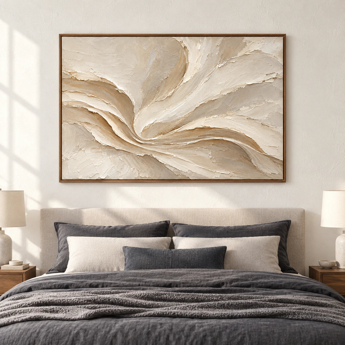 Satin-Whorl hangs above a simple upholstered bed in a quiet, sunlit bedroom with restrained neutral furnishings.