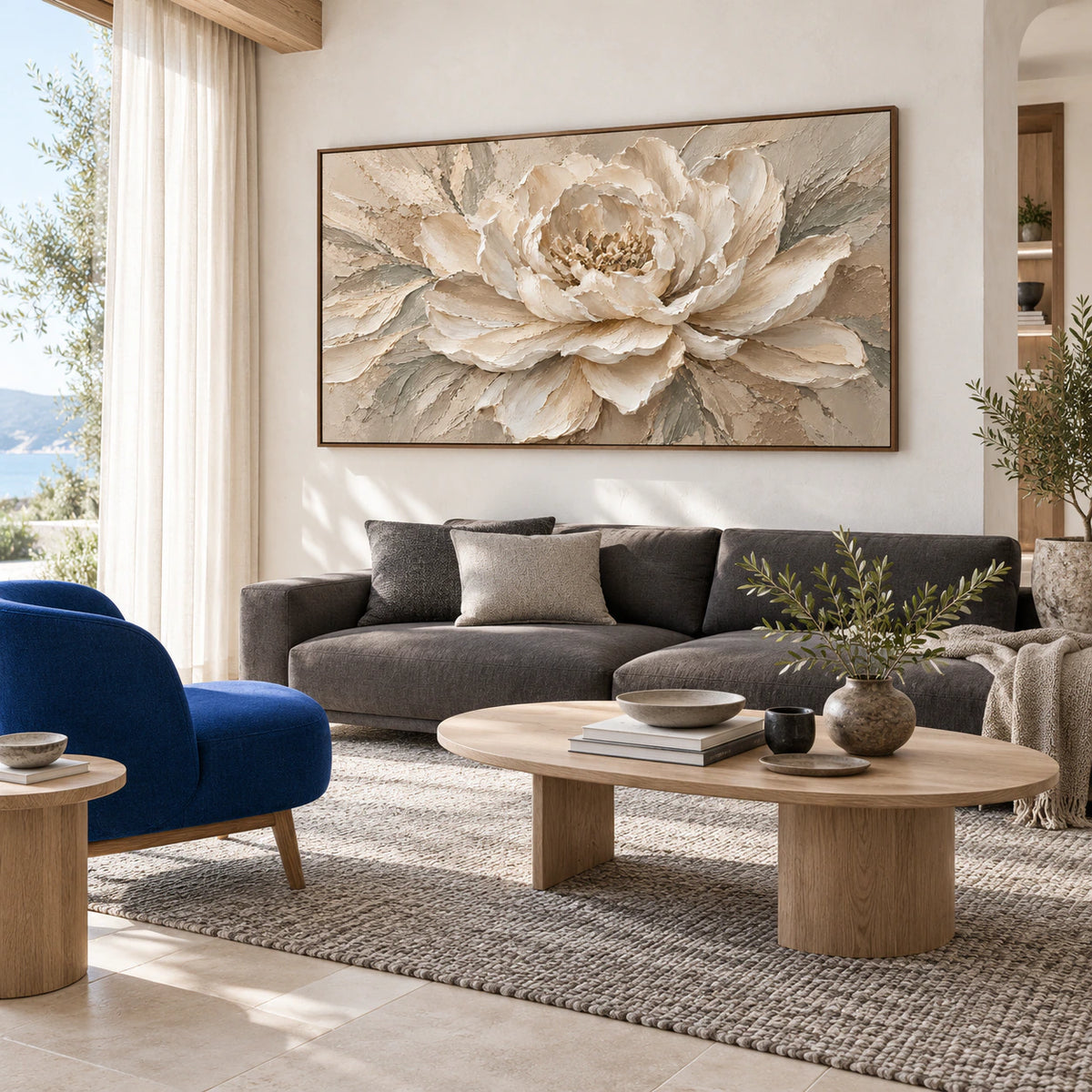 Bright living room with the large cream peony textured painting above a restrained sofa.