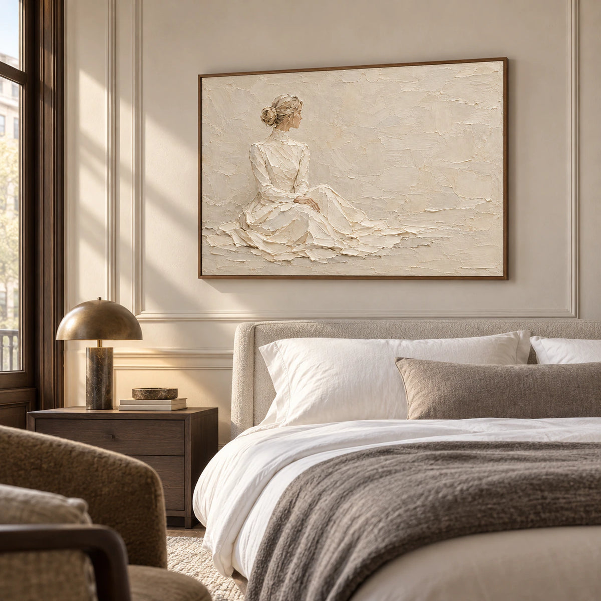 Seated-figure painting above a low upholstered bed in a quiet bedroom with pale stone walls, crisp linens, and gentle morning light.