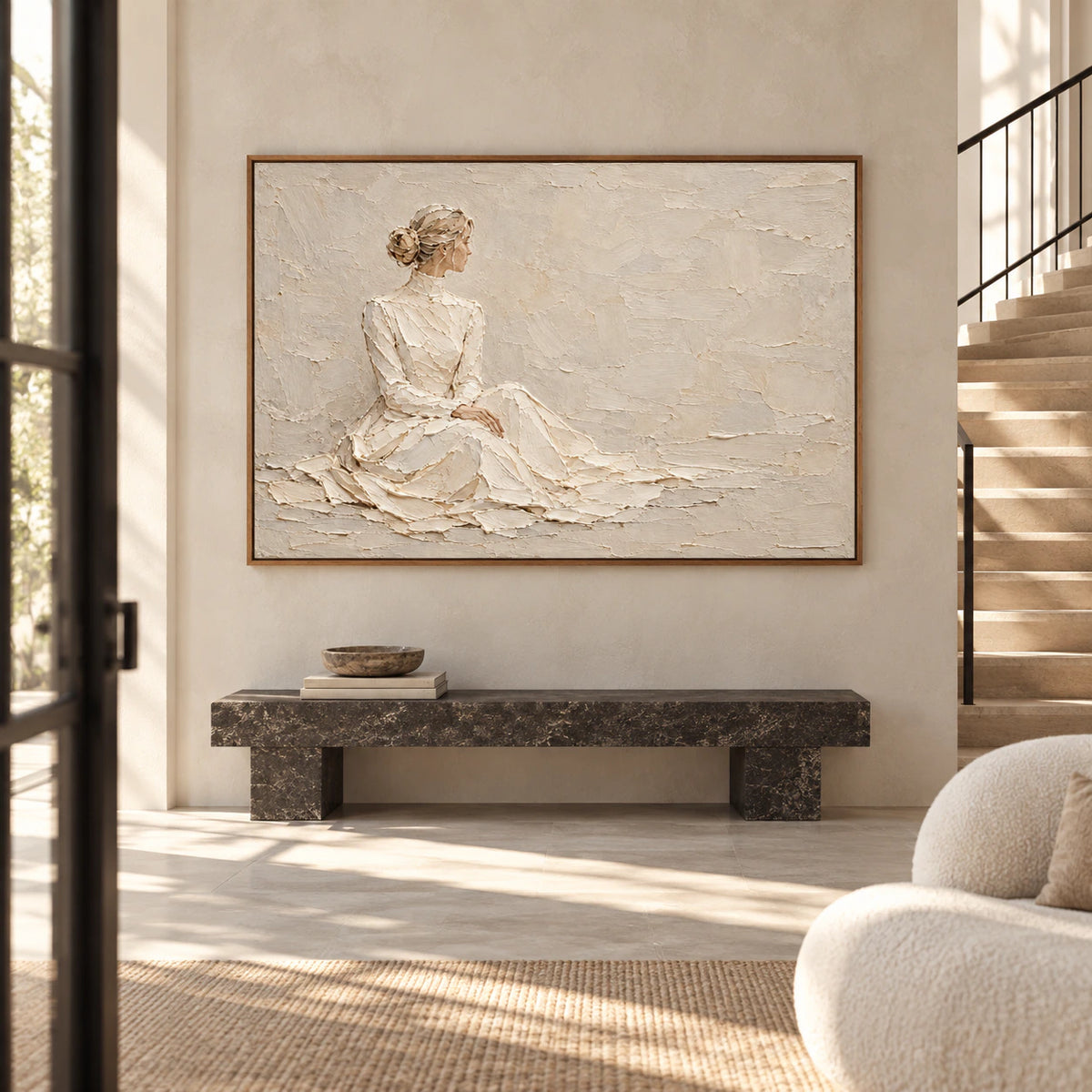 Horizontal textured figure painting on a tall foyer wall, framed by a dark stone bench, broad architectural stair, and clear daylight.