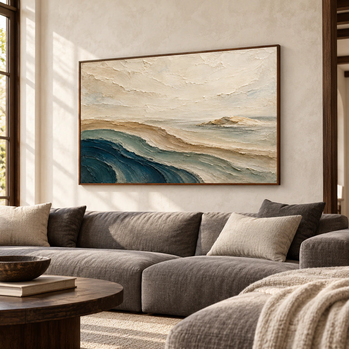 Large horizontal abstract landscape above a restrained sofa in a bright living room with natural daylight.