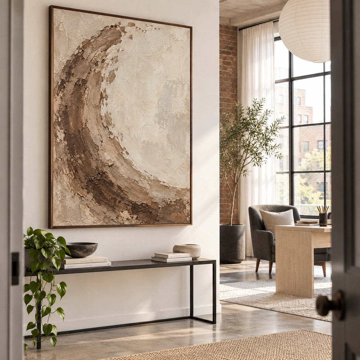 Vertical sienna and ivory textured abstract painting in an airy home office reading space.