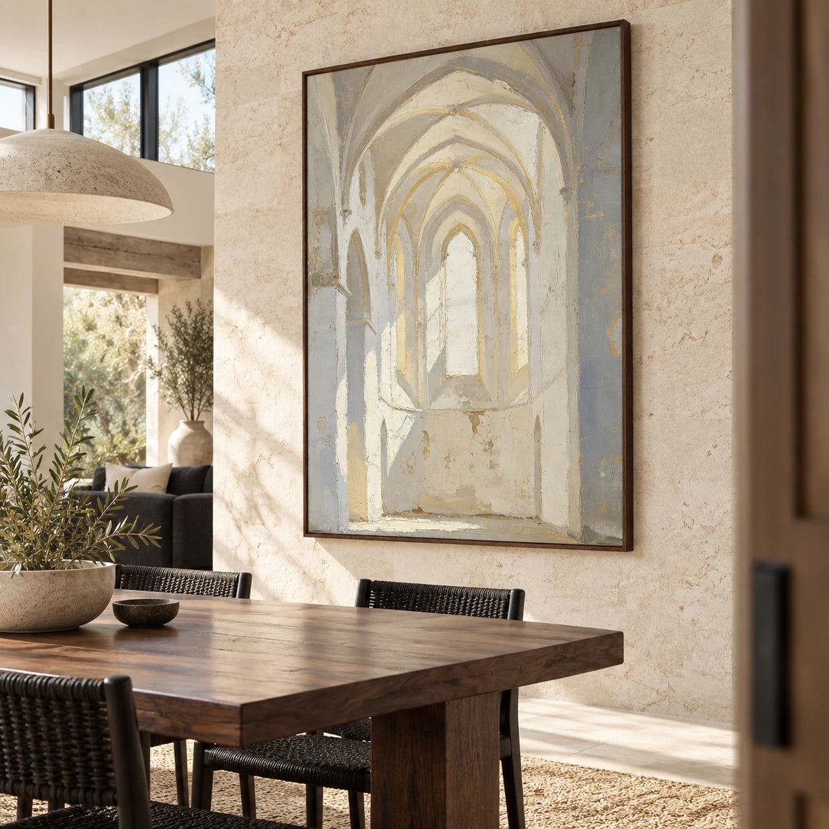 Textured ivory and grey arch painting above a refined dining setting in natural daylight.