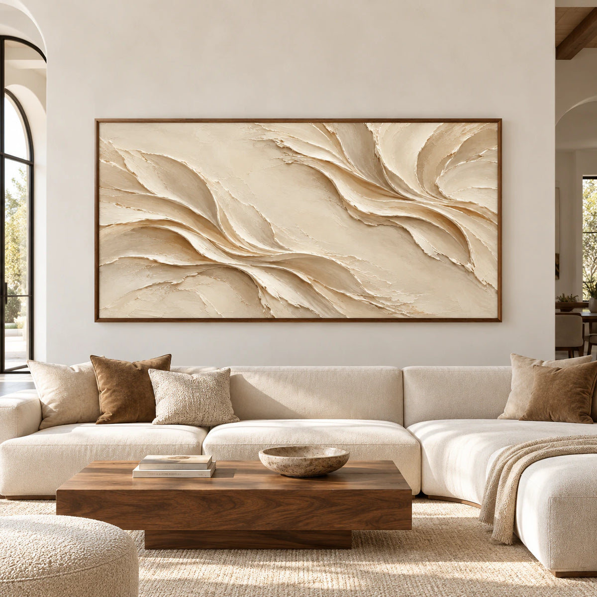 Large-scale straight-on view of Silken-Rills, an ivory and warm sand abstract artwork with sweeping raised folds, displayed prominently in a spacious, sunlit room.