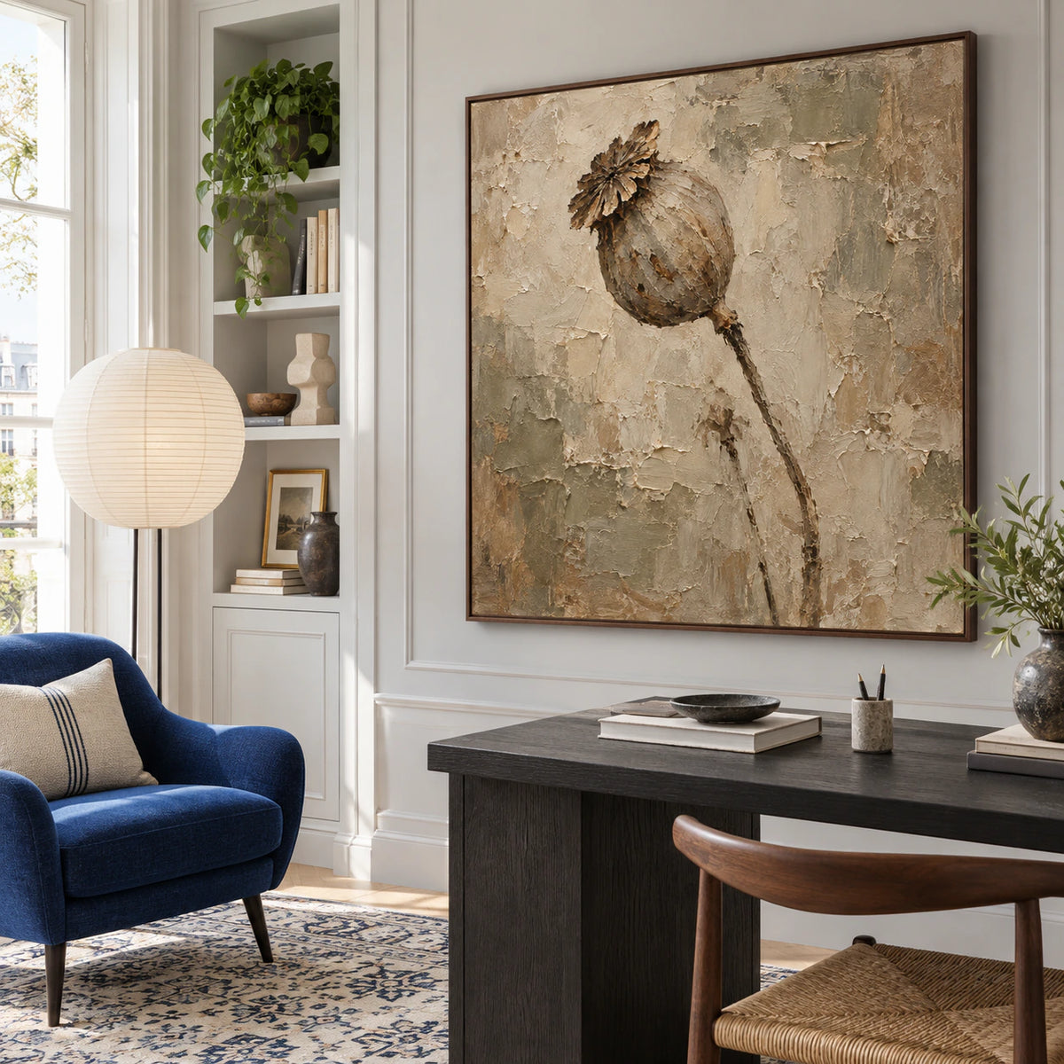 Large textured floral artwork in an airy daylight home office reading space.