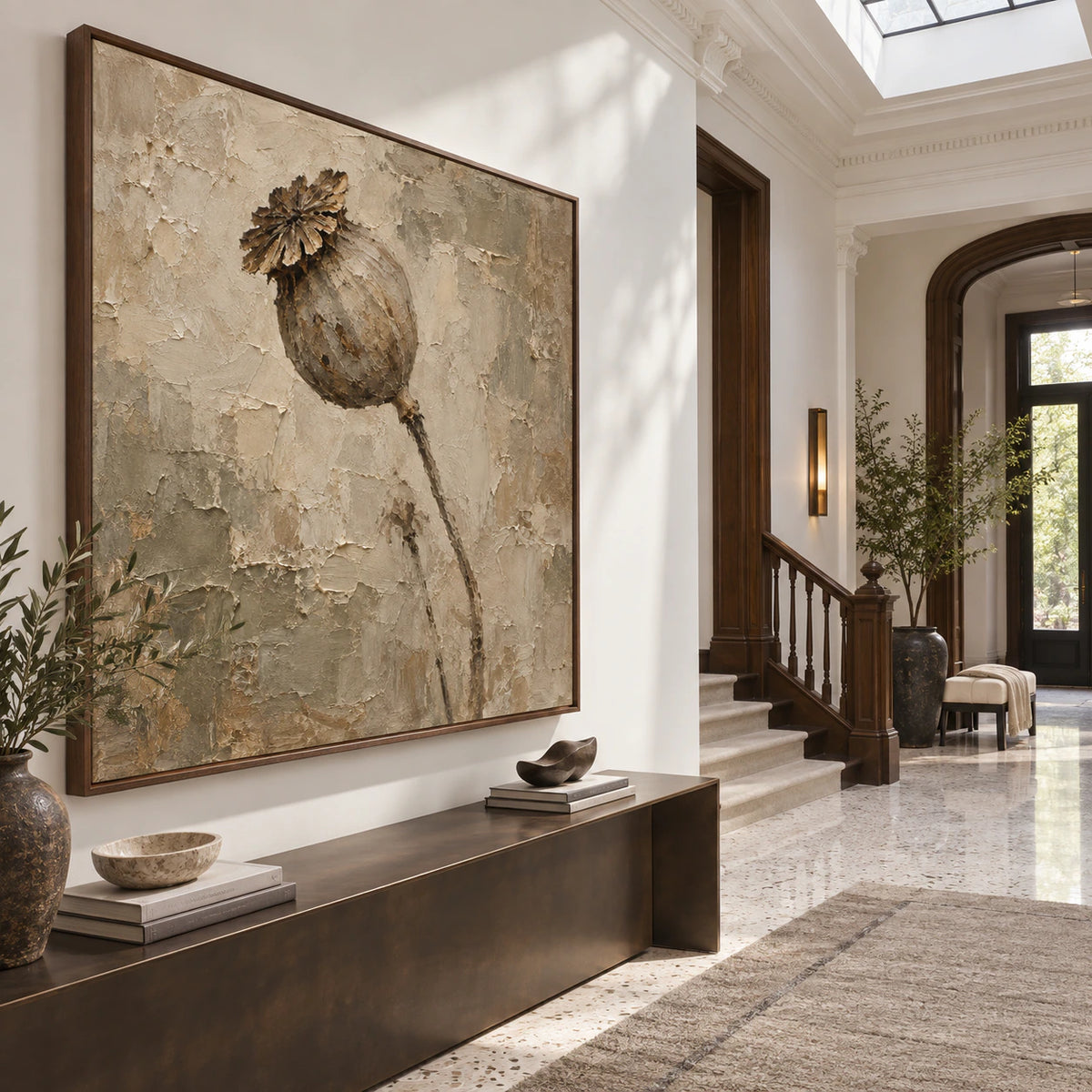 Square relief floral painting at gallery scale in a bright sculptural foyer.