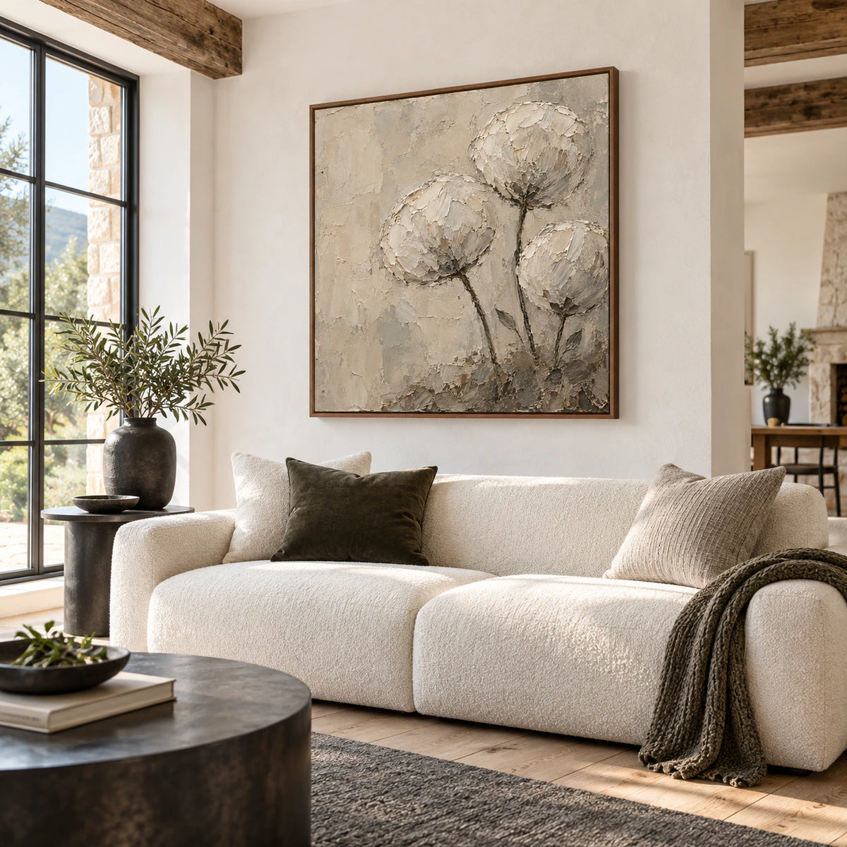 Square textured floral artwork above a neutral sofa in a bright living room.