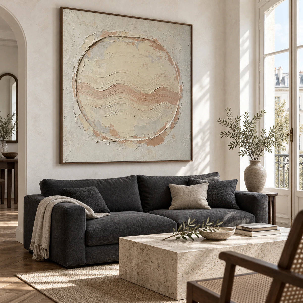 Square ivory and clay textured abstract painting above a bright, spacious living room seating arrangement.