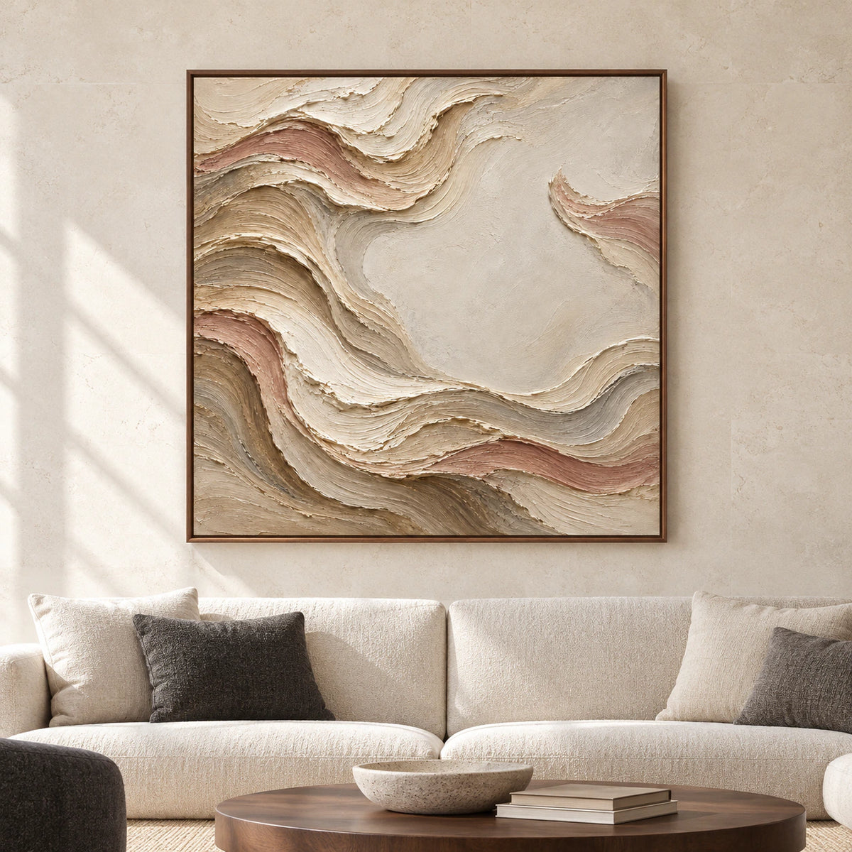 Square textured painting viewed straight-on on a pale limestone wall above low charcoal and natural wood furnishings in a spacious, daylight-filled room.