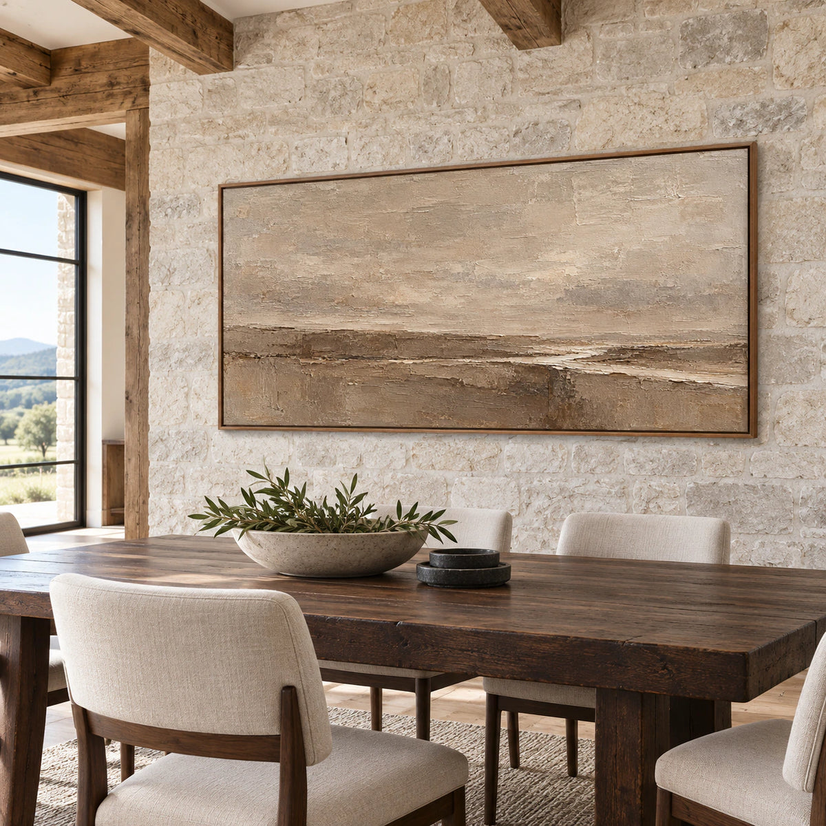 Large horizontal abstract painting on a cool light stone wall beside a dark wood dining table and restrained chairs, viewed from the right at seated eye level.
