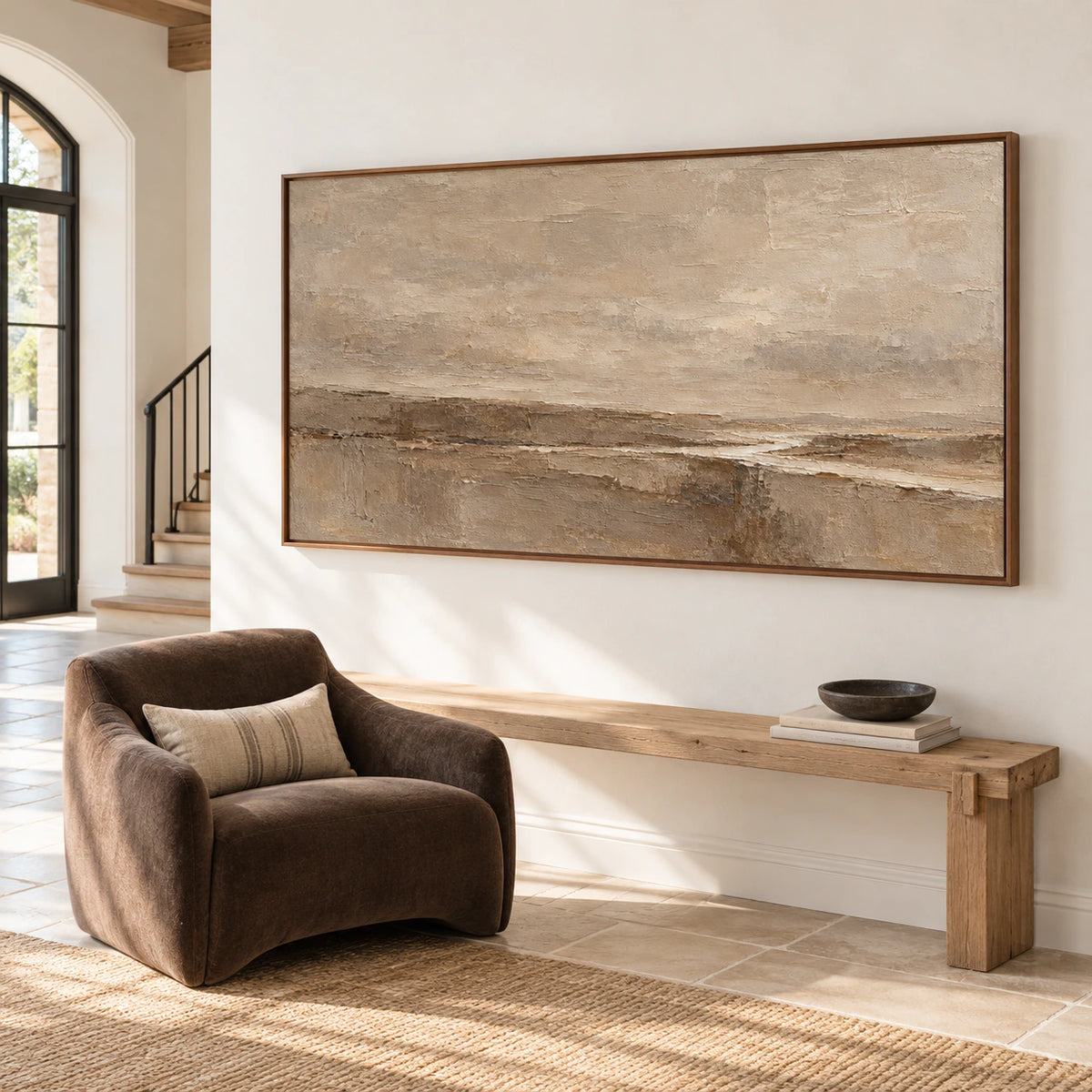 Large horizontal textured painting on a tall foyer wall above a pale stone floor with dark accents, viewed from the right in bright side daylight.