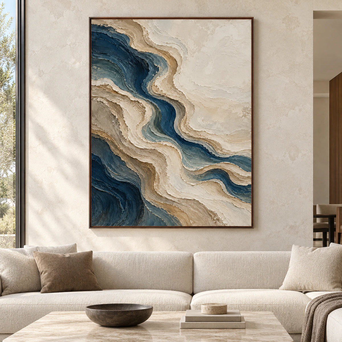Large vertical abstract painting with a winding deep blue channel and raised sand, taupe and ivory bands, shown straight-on in a spacious room.