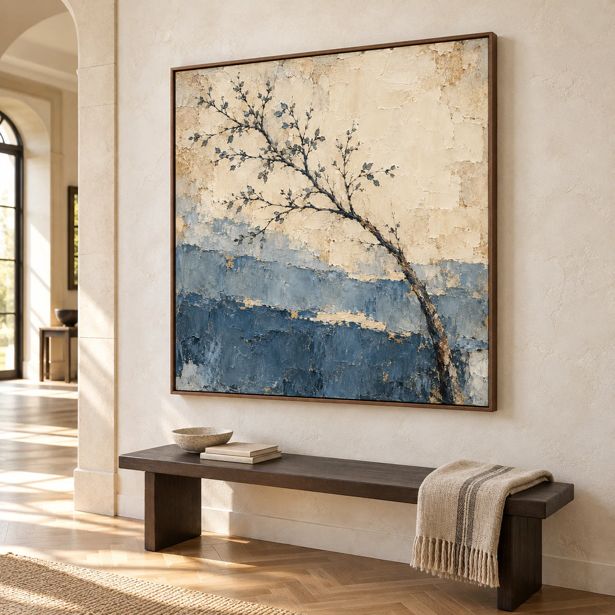 Large square Slate-Arbor painting on a tall light stone foyer wall beside a dark wood bench, viewed from farther back at a gentle right angle in bright daylight.