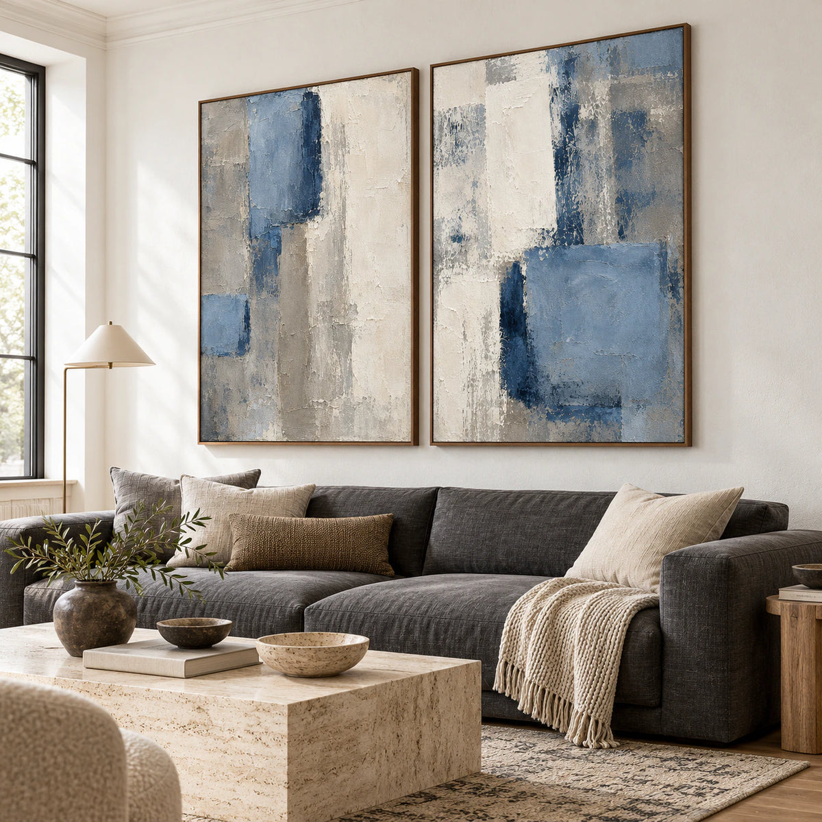 Slate-Quarters diptych above a sofa in a bright contemporary living room.